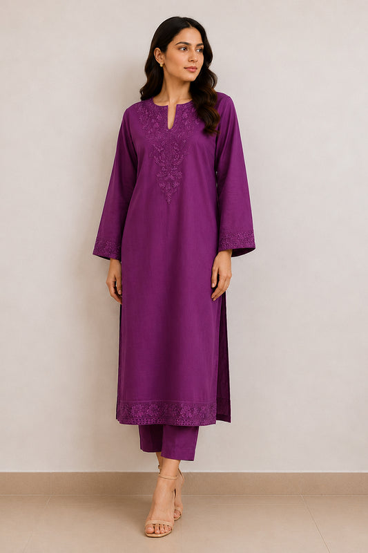 A woman modeling a purple long kurta with matching pants. The kurta features a split neckline with embroidered detailing on the chest and a matching embroidered border at the hem.